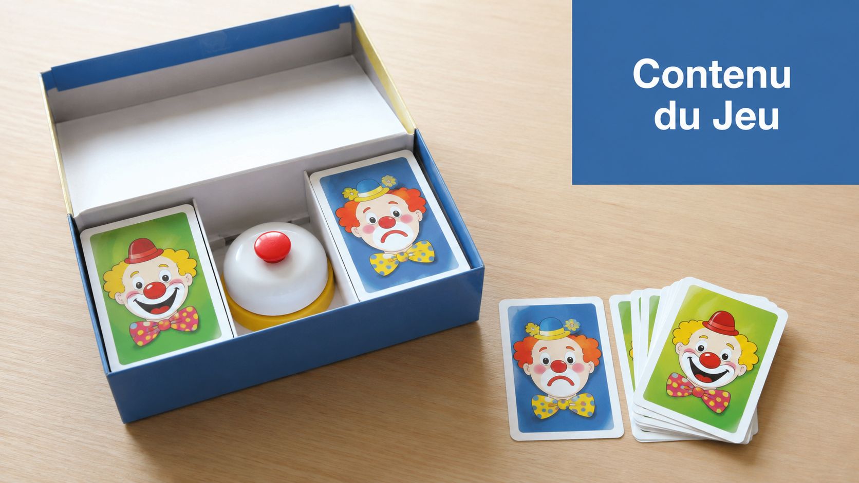 Une boîte de jeu de société Halli Galli Junior ouverte avec des cartes clowns et une sonnette rouge.